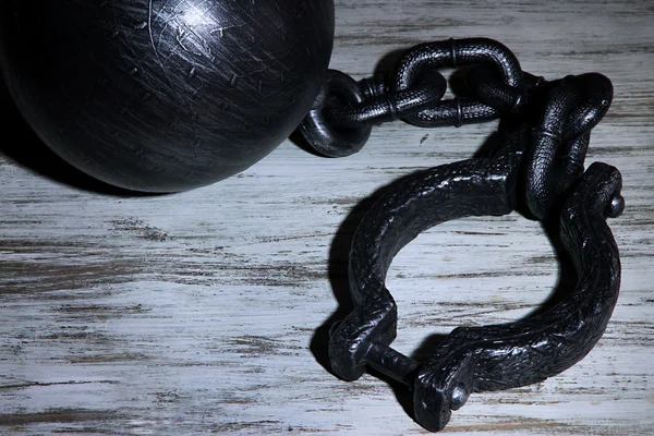 Ball and chain on wooden background — Stock Photo, Image