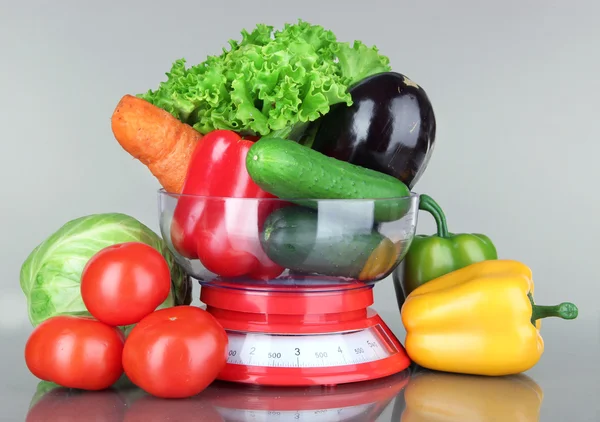 Fresh vegetables in scales on gray background — Stock Photo, Image