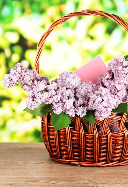 Beautiful lilac flowers on table on bright background — Stock Photo, Image