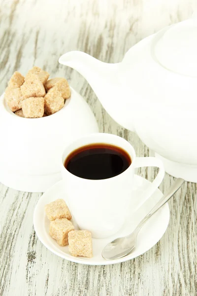 Cup of coffee, teapot and sugar-bowl on color wooden background — Stock Photo, Image