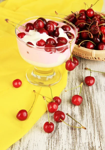 Delicious cherry dessert in glass vase on wooden table close-up — Stock Photo, Image