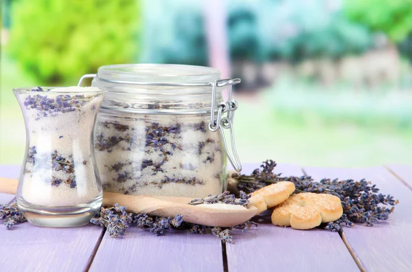 Jar of lavender sugar and fresh lavender flowers on bright background — Stock Photo, Image