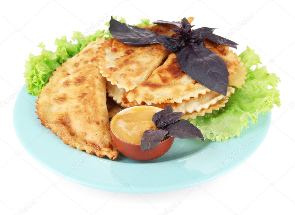 Tasty cheburek with fresh herbs on plate, isolated on white