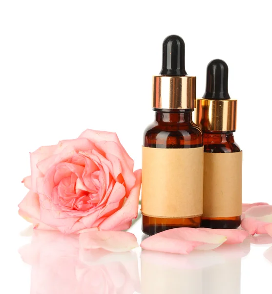 Bottles of oil and rose isolated on white — Stock Photo, Image