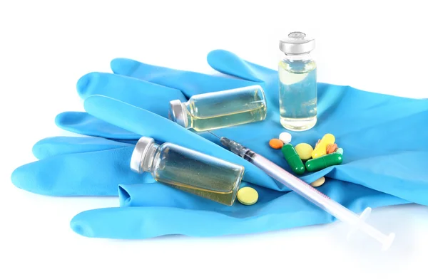 Medical bottles gloves and syringe isolated on white — Stock Photo, Image