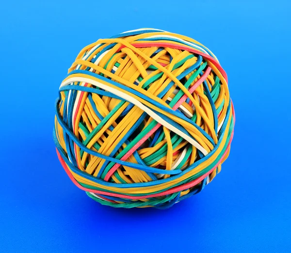 Colorful rubber bands on blue background — Stock Photo, Image