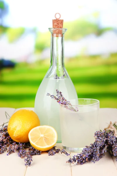 Lavender lemonade in bottle, on bright background — Stock Photo, Image