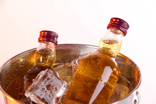 Mini Bar şişe üzerinde beyaz izole buz küpleri ile kova — Stok fotoğraf