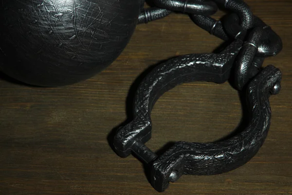 Ball and chain on wooden background — Stock Photo, Image