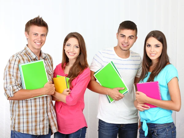 Group of happy beautiful young students at room — Stock Photo, Image