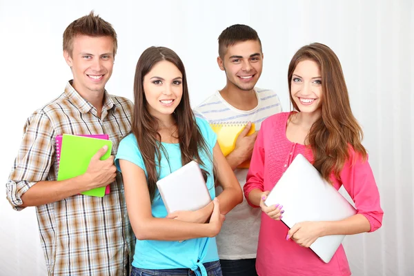 Group of happy beautiful young students at room Stock Photo