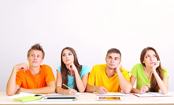 Grupo de jóvenes estudiantes sentados en la habitación — Foto de Stock