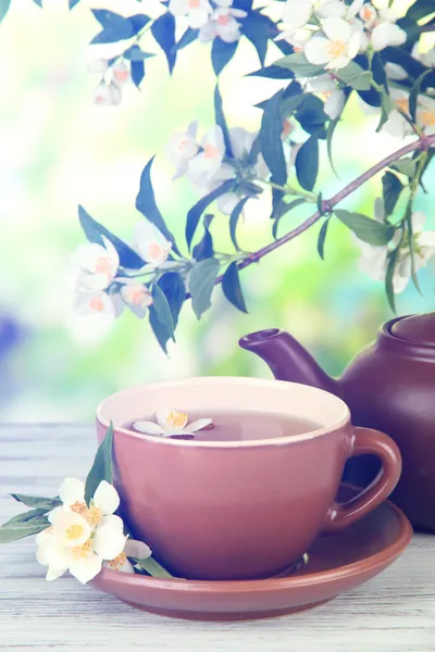 Cup of tea with jasmine, on bright background — Stock Photo, Image