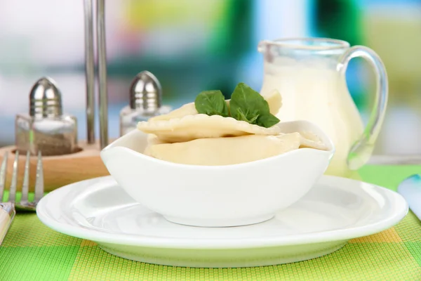 Tasty dumplings on white plate, on bright background — Stock Photo, Image