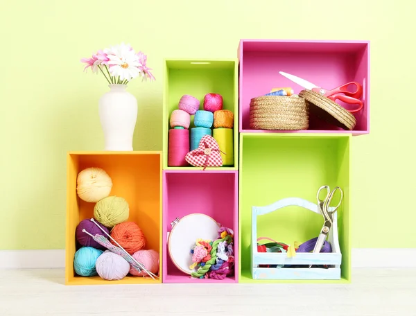 Colorful shelves of different colors with utensils on wall background — Stock Photo, Image