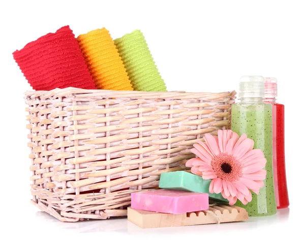 Asciugamani colorati in cestino, bottiglie di cosmetici e sapone, isolati su bianco — Foto Stock