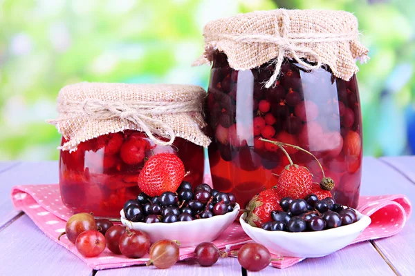 Home made berry jam on wooden table on bright background — Stock Photo, Image