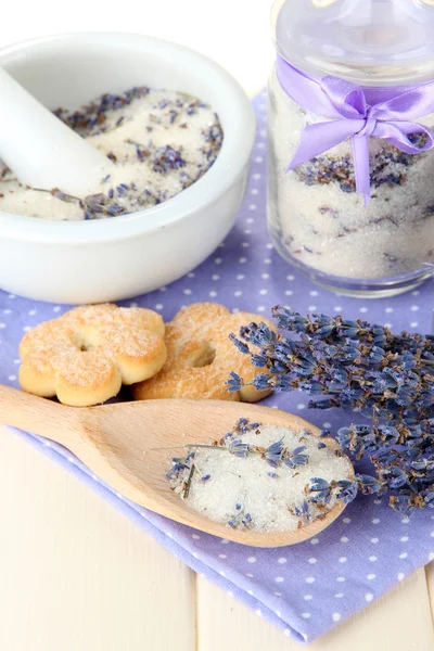 Still life with jar of lavender sugar, mortar and fresh lavender flowers on wooden background — Stock Photo, Image