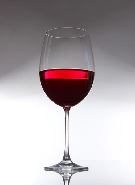 Glass of wine on gray background — Stock Photo, Image