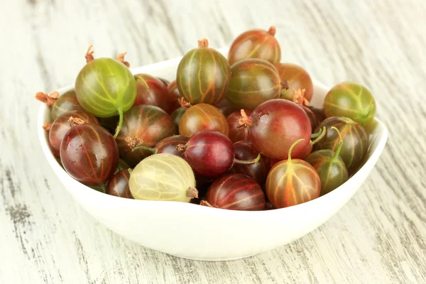 Fresh gooseberries in bowl on table close-up Stock Image