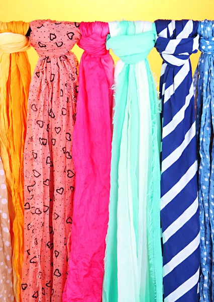 Colored scarves on orange background — Stock Photo, Image