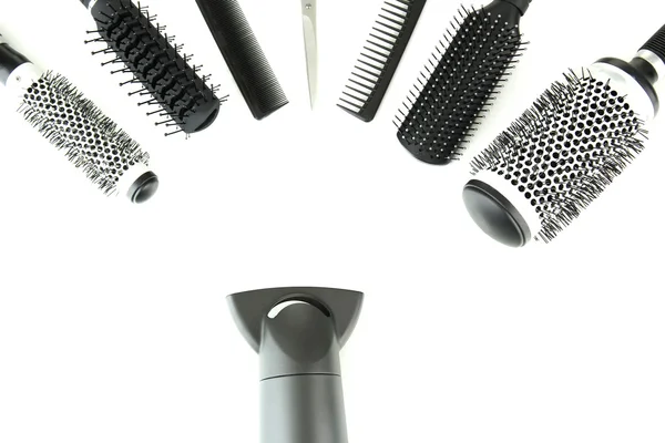 Comb brushes, hairdryer and cutting shears, isolated on white — Stock Photo, Image