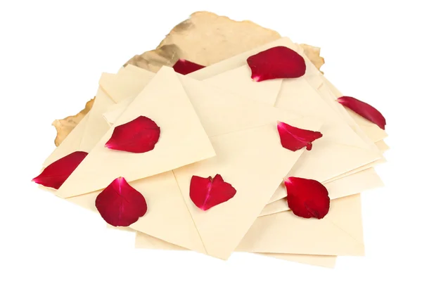 Pile of old letters with dried rose petals isolated on white — Stock Photo, Image