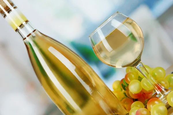 Vinho branco em vidro com garrafa em salver no fundo do quarto — Fotografia de Stock