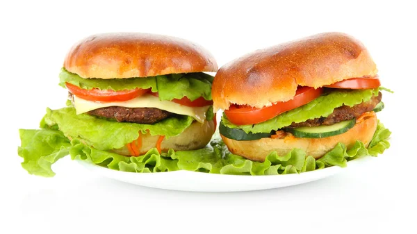 Big and tasty hamburgers on plate isolated on white — Stock Photo, Image