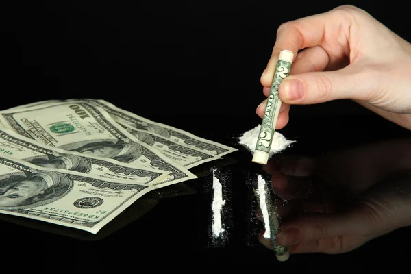 Cocaine drugs lines and female hand holding rolled dollar banknote, close up — Stock Photo, Image
