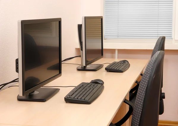 Computers on tables in room — Stock Photo, Image