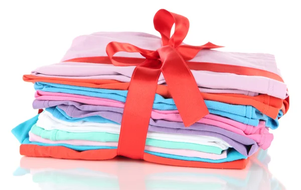 Pile of clothing with red ribbon and bow isolated on white — Stock Photo, Image