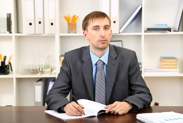 Young businessman in office at his workplace — Stock Photo, Image