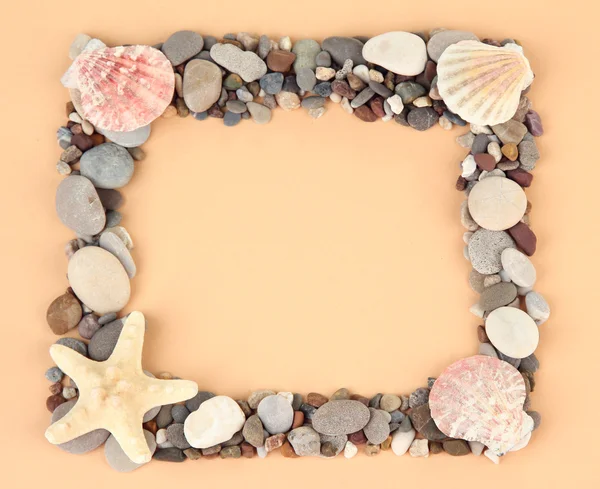 Frame of sea stones on color background — Stockfoto