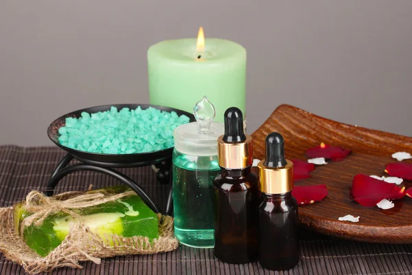 Spa composition with aroma oils on table on gray background — Stock Photo, Image