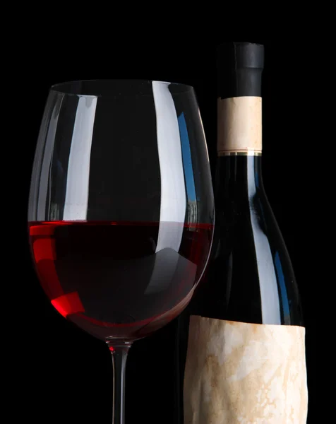 Glass of wine with bottle on bright background — Stock Photo, Image