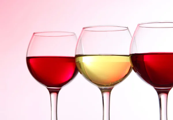 Glasses of wine on light pink tone — Stock Photo, Image