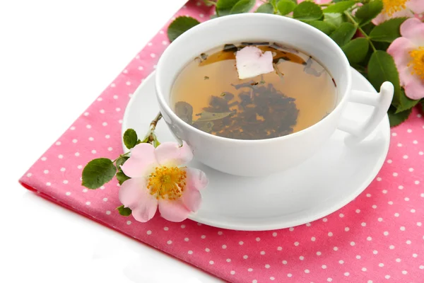 Cup of herbal tea with hip rose flowers, isolated on white — Stock Photo, Image