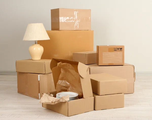 Moving boxes on the floor in empty room — Stock Photo, Image