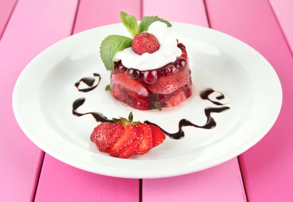 Tasty jelly dessert with fresh berries, on color wooden background — Stock Photo, Image