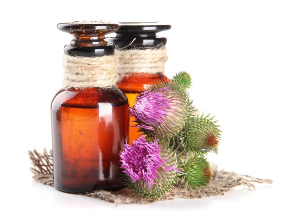 Medicine bottles with thistle flowers, isolated on white — Stock Photo, Image