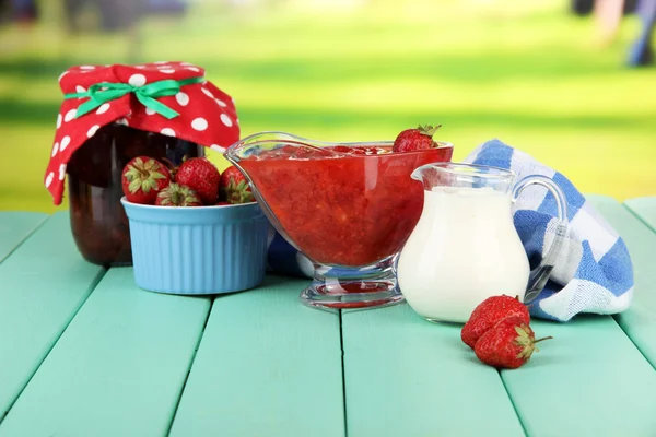 Homemade strawberry jam, on napkin, on color wooden table, on bright background — Stock Photo, Image