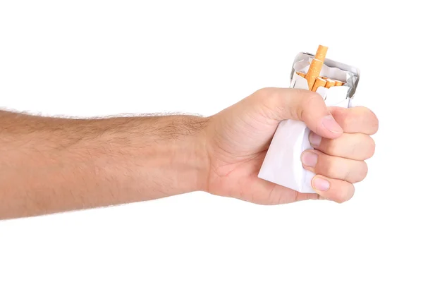 Vuist met verpletterd pack van sigaretten, geïsoleerd op wit — Stockfoto