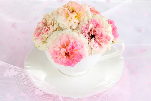 Roses en tasse sur fond rose clair — Photo