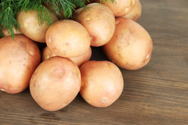 Potato on wooden table — Stock Photo, Image