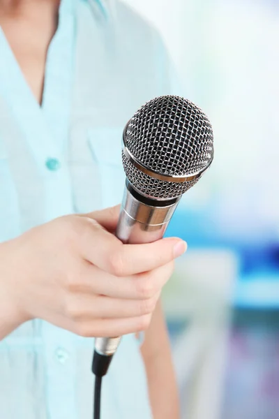 Female with microphone on room background — Stock Photo, Image