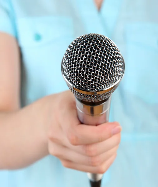Female with microphone close-up background — Stock Photo, Image