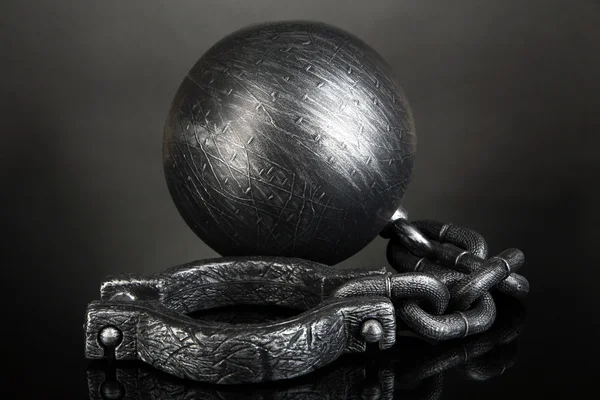 Ball and chain on grey background — Stock Photo, Image