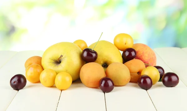 Helle Sommerfrüchte auf Holztisch vor natürlichem Hintergrund — Stockfoto