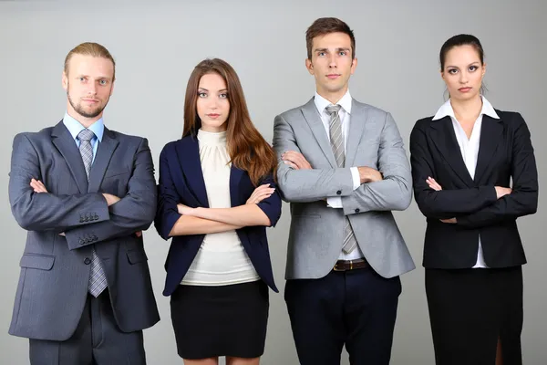 Business team standing in row on grey background Royalty Free Stock Images